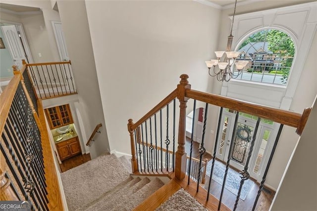 9065 Yellow Pine Ct, Gainesville, GA 30506 - staircase with wood finished floors, a chandelier, crown molding, and a high ceiling