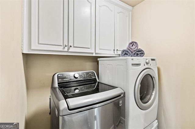 9065 Yellow Pine Ct, Gainesville, GA 30506 - laundry room featuring washing machine and dryer and cabinet space