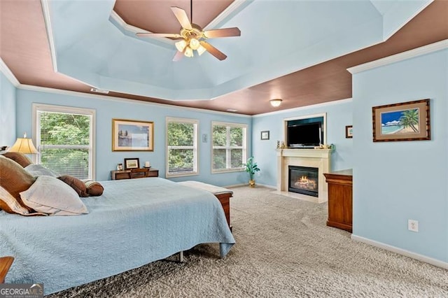 9065 Yellow Pine Ct, Gainesville, GA 30506 - carpeted bedroom with a raised ceiling, ornamental molding, a fireplace with flush hearth, and ceiling fan