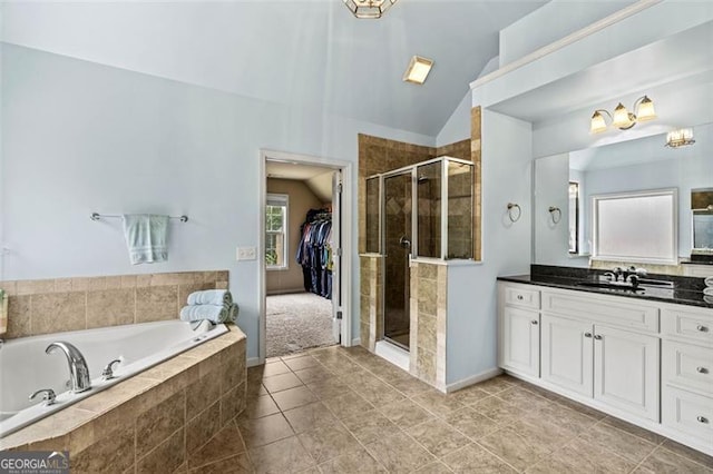 9065 Yellow Pine Ct, Gainesville, GA 30506 - bathroom with vanity, a bath, a stall shower, lofted ceiling, and tile patterned flooring