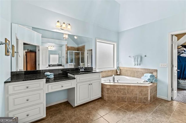 9065 Yellow Pine Ct, Gainesville, GA 30506 - full bathroom featuring vanity, a shower stall, a garden tub, a walk in closet, and tile patterned flooring