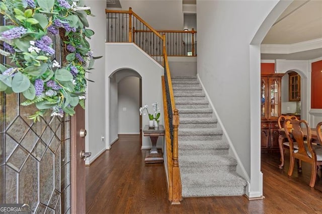 9065 Yellow Pine Ct, Gainesville, GA 30506 - entrance foyer with arched walkways, stairway, wood finished floors, and ornamental molding