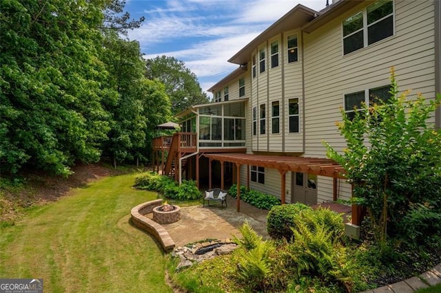 9065 Yellow Pine Ct, Gainesville, GA 30506 - view of grassy yard with a fire pit, a deck, a patio, a sunroom, and stairs