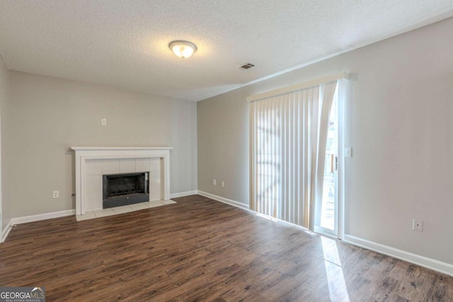 2105 Sandtree Ct SW, Atlanta, GA 30331 - unfurnished living room with plenty of natural light, wood finished floors, a textured ceiling, and a tile fireplace