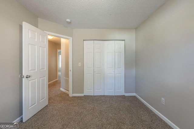 2105 Sandtree Ct SW, Atlanta, GA 30331 - unfurnished bedroom featuring a textured ceiling, a closet, and carpet floors