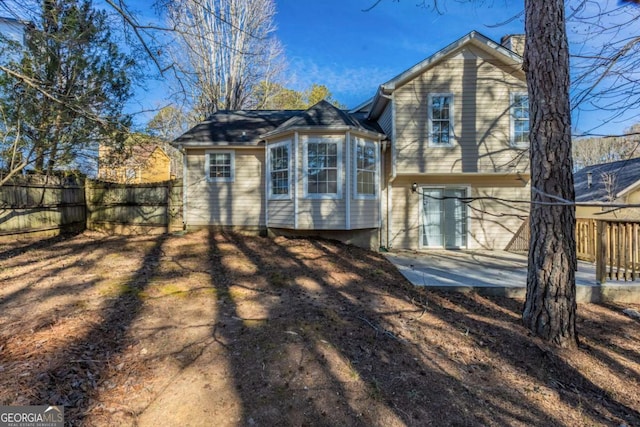 2105 Sandtree Ct SW, Atlanta, GA 30331 - rear view of house with a chimney and a patio area