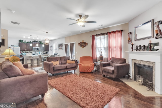 3929 Makeover Ct Unit 0, Atlanta, GA 30349 - living area featuring ceiling fan, hardwood / wood-style floors, and a fireplace with flush hearth