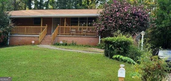 1723 Fort Valley Dr, Atlanta, GA 30311 - view of front facade featuring a front lawn, a porch, and stairway