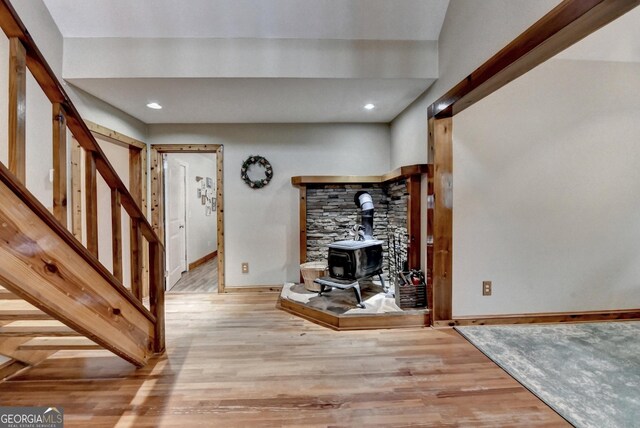 1365 Lower Creighton Rd, Cumming, GA 30028 - living area with light wood-style flooring, a wood stove, stairs, and recessed lighting
