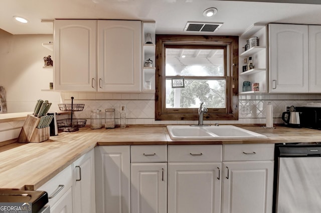 1365 Lower Creighton Rd, Cumming, GA 30028 - kitchen with open shelves, wooden counters, stainless steel dishwasher, backsplash, and white cabinetry