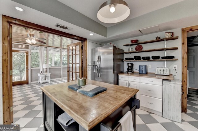 1365 Lower Creighton Rd, Cumming, GA 30028 - kitchen with light flooring, stainless steel fridge with ice dispenser, open shelves, white cabinetry, and wooden counters
