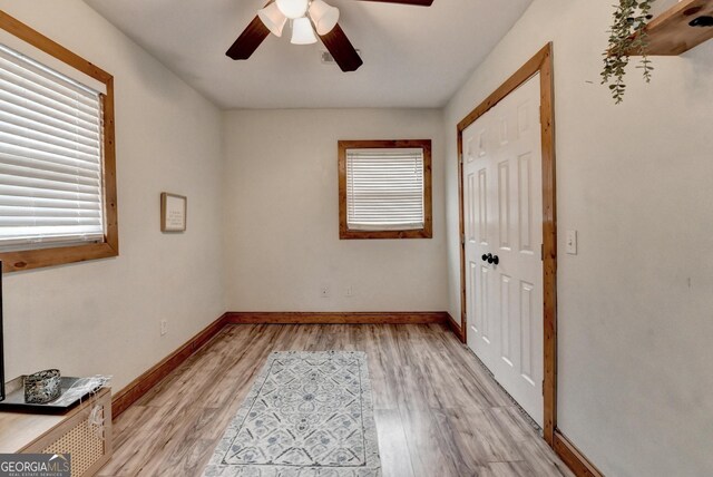 1365 Lower Creighton Rd, Cumming, GA 30028 - unfurnished bedroom with multiple windows, a closet, light wood-style flooring, and ceiling fan