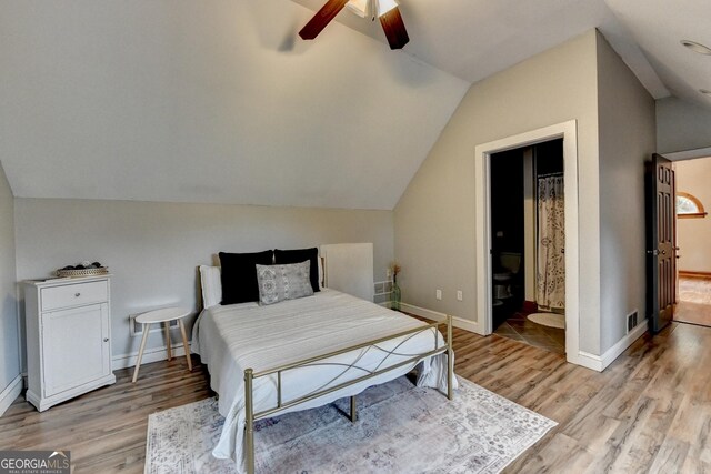 1365 Lower Creighton Rd, Cumming, GA 30028 - bedroom with light wood-type flooring, lofted ceiling, connected bathroom, and a ceiling fan