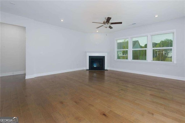 740 Pineberry Ct, Grayson, GA 30017 - unfurnished living room with a ceiling fan, a fireplace with flush hearth, wood finished floors, and recessed lighting