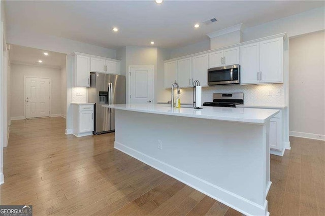 740 Pineberry Ct, Grayson, GA 30017 - kitchen featuring appliances with stainless steel finishes, white cabinetry, tasteful backsplash, light countertops, and recessed lighting