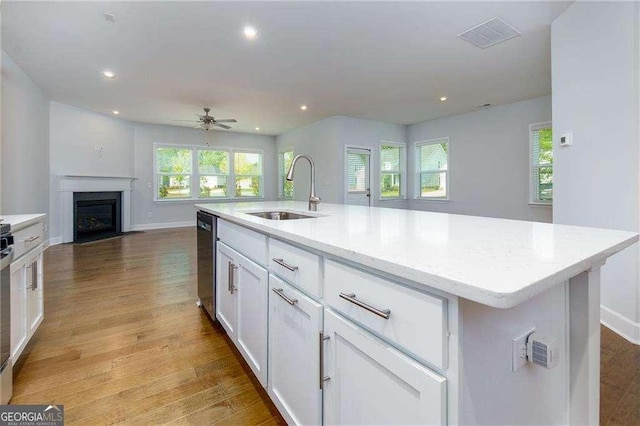 740 Pineberry Ct, Grayson, GA 30017 - kitchen with open floor plan, white cabinetry, stainless steel dishwasher, recessed lighting, and light wood finished floors