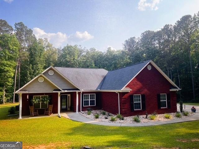 4954 Ga Highway 109, Molena, GA 30258 - view of front of property with a front yard, brick siding, and a porch