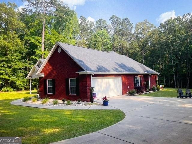 4954 Ga Highway 109, Molena, GA 30258 - view of property exterior with a lawn, driveway, an attached garage, and brick siding