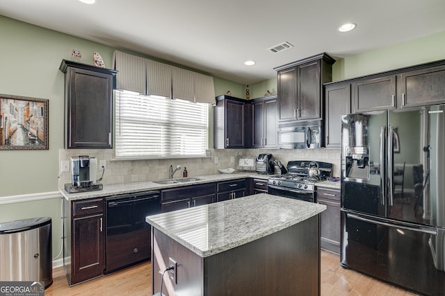 3393 Sardis Bend Dr, Buford, GA 30519 - kitchen featuring black appliances, a sink, decorative backsplash, light wood-type flooring, and a kitchen island