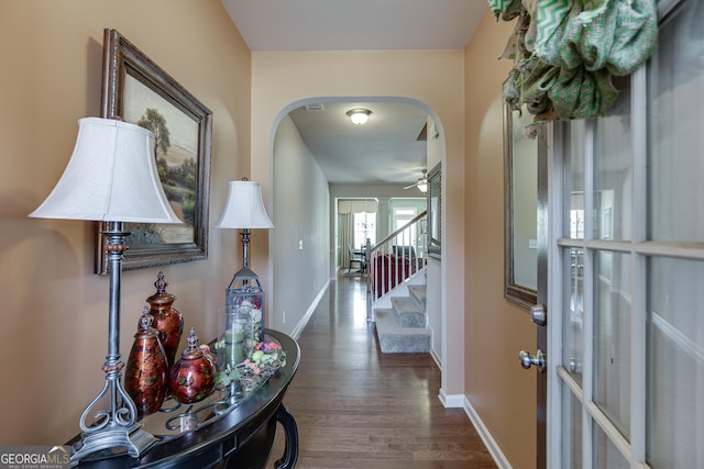 3393 Sardis Bend Dr, Buford, GA 30519 - hall featuring arched walkways, dark wood finished floors, baseboards, and stairway