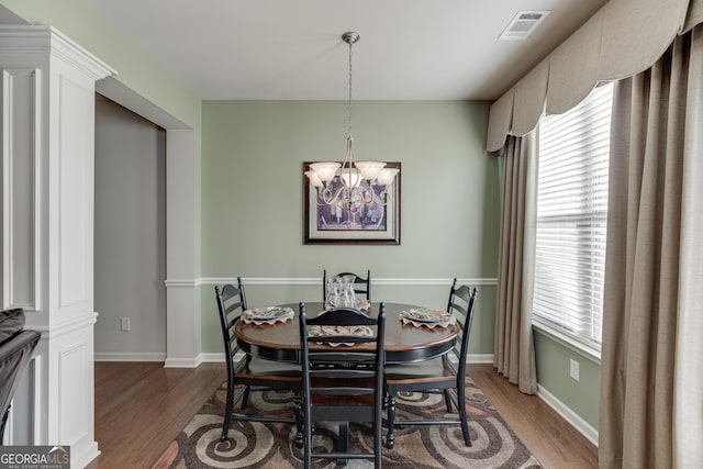 3393 Sardis Bend Dr, Buford, GA 30519 - dining space with wood finished floors, a chandelier, and baseboards