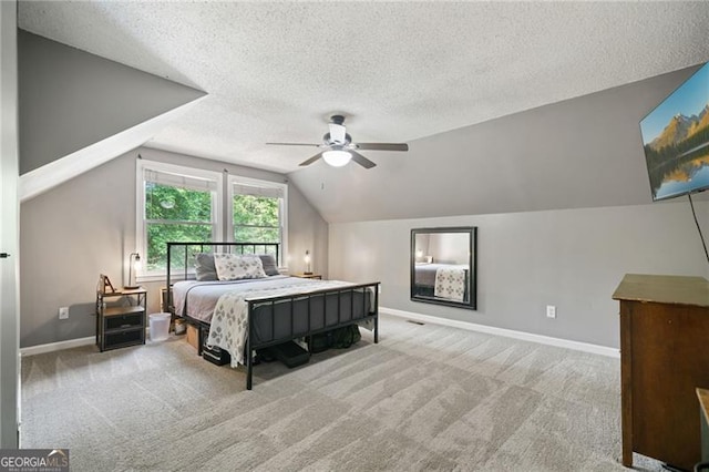 76 Beech Creek Cir, Winder, GA 30680 - bedroom featuring a textured ceiling, baseboards, carpet floors, vaulted ceiling, and ceiling fan