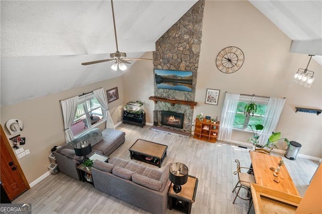 76 Beech Creek Cir, Winder, GA 30680 - living area featuring high vaulted ceiling, wood finished floors, a ceiling fan, a fireplace, and baseboards