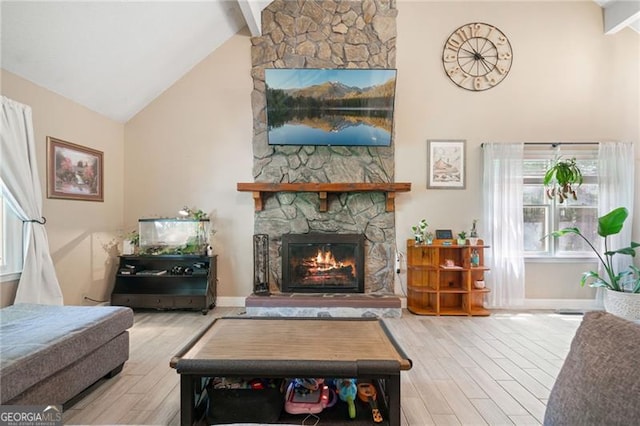 76 Beech Creek Cir, Winder, GA 30680 - living area featuring high vaulted ceiling, wood finished floors, a fireplace, plenty of natural light, and beamed ceiling