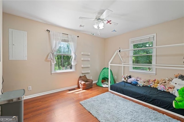 76 Beech Creek Cir, Winder, GA 30680 - bedroom featuring wood finished floors, baseboards, electric panel, and ceiling fan