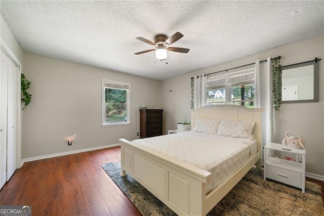 76 Beech Creek Cir, Winder, GA 30680 - bedroom with multiple windows, hardwood / wood-style floors, baseboards, and a textured ceiling