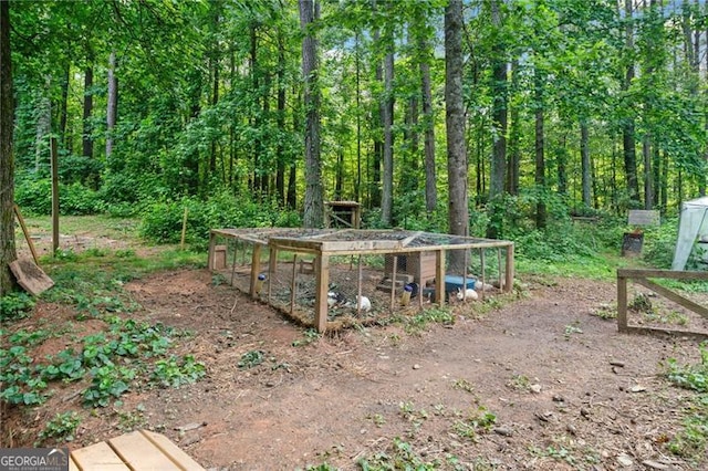 76 Beech Creek Cir, Winder, GA 30680 - view of yard featuring exterior structure, an outdoor structure, and a view of trees