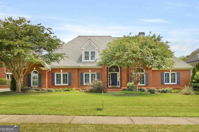 718 First Cotton Dr, Powder Springs, GA 30127 - view of front of house featuring brick siding, a front yard, and a chimney