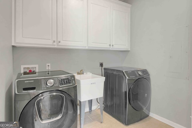 718 First Cotton Dr, Powder Springs, GA 30127 - washroom with cabinet space, light tile patterned floors, and washing machine and dryer