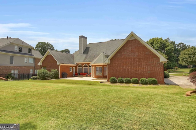 718 First Cotton Dr, Powder Springs, GA 30127 - rear view of property featuring brick siding, a patio, and a chimney