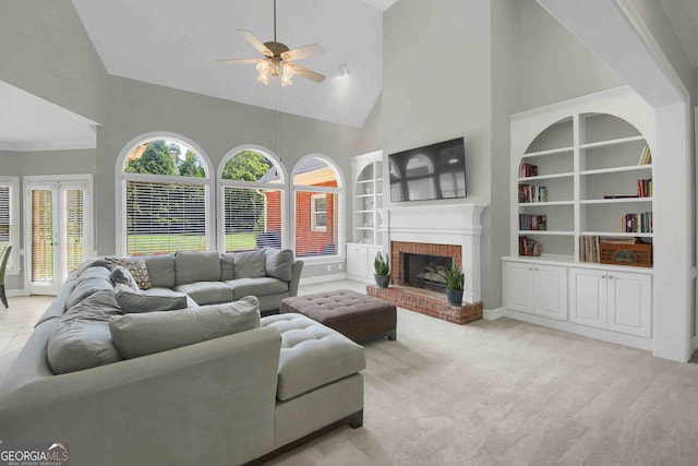 718 First Cotton Dr, Powder Springs, GA 30127 - living area with high vaulted ceiling, ceiling fan, built in shelves, carpet, and a brick fireplace