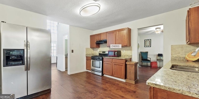 475 Cascade Rise Ct, South Fulton, GA 30331 - kitchen featuring appliances with stainless steel finishes, under cabinet range hood, dark wood-style floors, backsplash, and a textured ceiling