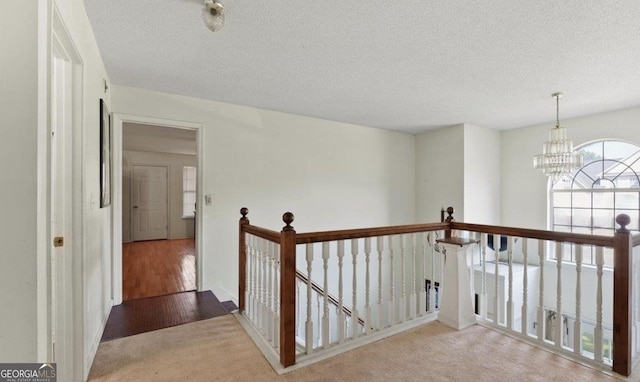 475 Cascade Rise Ct, South Fulton, GA 30331 - hall featuring an upstairs landing, carpet flooring, a chandelier, and a textured ceiling