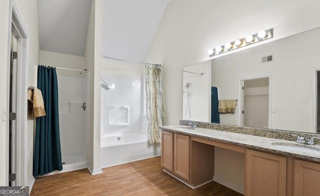 475 Cascade Rise Ct, South Fulton, GA 30331 - bathroom with wood finished floors, double vanity, and vaulted ceiling