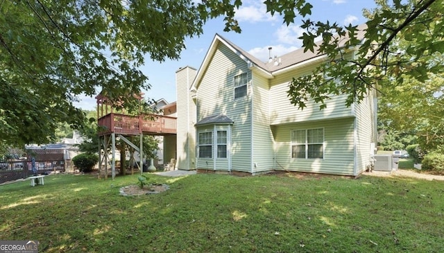 475 Cascade Rise Ct, South Fulton, GA 30331 - back of property with a wooden deck, a lawn, and a chimney