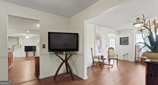 475 Cascade Rise Ct, South Fulton, GA 30331 - living area with wood finished floors, a ceiling fan, a textured ceiling, and stairway