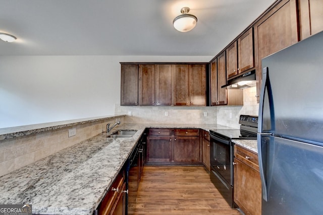 5831 Taka Ln, Lithonia, GA 30038 - kitchen with black appliances, a sink, under cabinet range hood, and decorative backsplash