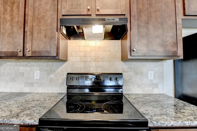 5831 Taka Ln, Lithonia, GA 30038 - kitchen with electric range, exhaust hood, tasteful backsplash, and light stone counters