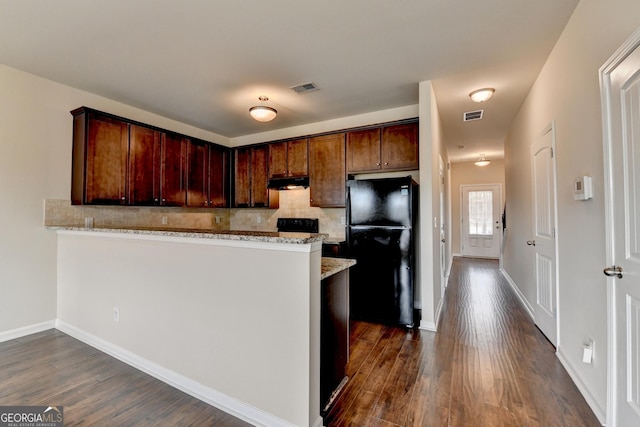 5831 Taka Ln, Lithonia, GA 30038 - kitchen with freestanding refrigerator, under cabinet range hood, backsplash, and dark wood-style floors