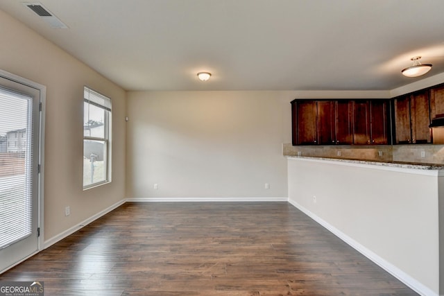 5831 Taka Ln, Lithonia, GA 30038 - kitchen with dark wood-style floors, backsplash, baseboards, and light stone counters