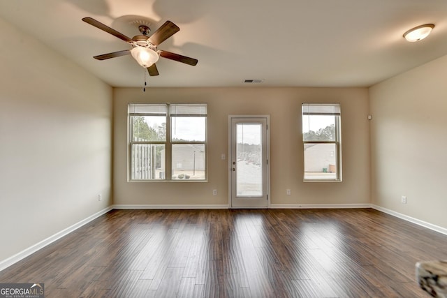 5831 Taka Ln, Lithonia, GA 30038 - empty room with ceiling fan, plenty of natural light, and dark wood-style flooring