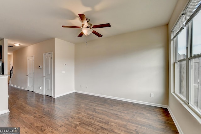 5831 Taka Ln, Lithonia, GA 30038 - empty room with a ceiling fan, dark wood-style flooring, and baseboards