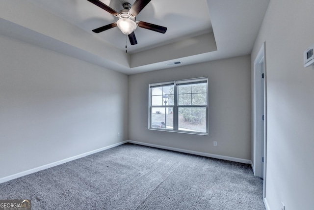 5831 Taka Ln, Lithonia, GA 30038 - spare room featuring carpet flooring, baseboards, a raised ceiling, and a ceiling fan