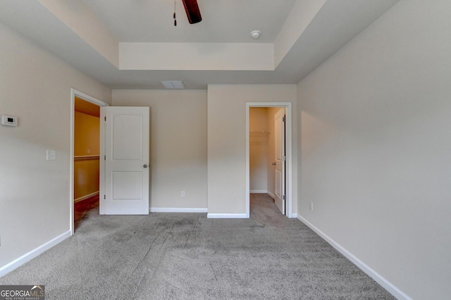 5831 Taka Ln, Lithonia, GA 30038 - unfurnished bedroom with a raised ceiling, carpet flooring, a walk in closet, and baseboards