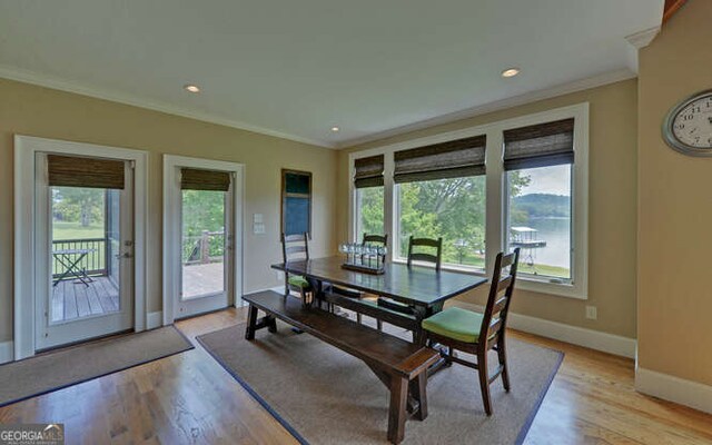 2156 Mockingbird Ln, Hiawassee, GA 30546 - dining area featuring crown molding, healthy amount of natural light, baseboards, and light wood-style floors