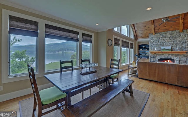 2156 Mockingbird Ln, Hiawassee, GA 30546 - dining room with wood finished floors, a ceiling fan, baseboards, a stone fireplace, and recessed lighting